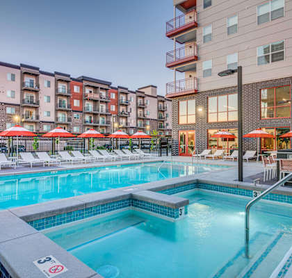 A swimming pool with a hot tub in the middle of it.