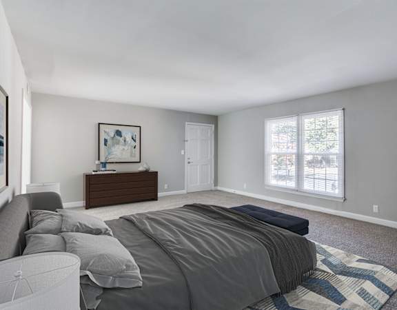 a bedroom with grey walls and carpet at The Mason Mills Apartments, Georgia, 30033