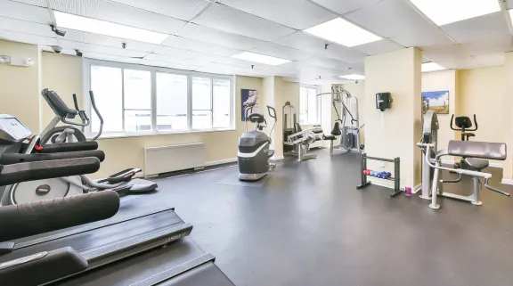 A spacious gym with treadmills, elliptical machines, and other exercise equipment. at Ashton Heights Apartments, Suitland, MD