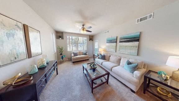 a living room with a couch and a table at The Passage by Picerne, Henderson, NV, 89014