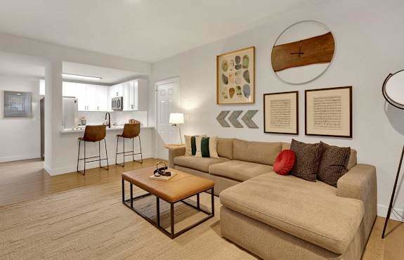 A living room with a couch, chairs, and a coffee table.