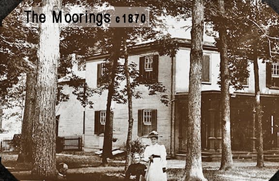 a woman is standing in front of a house