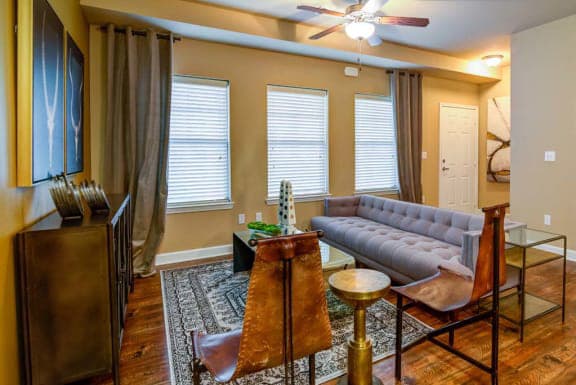 a living room with a couch and a table  at The Retreat Apartment Homes, North Dakota, 58801