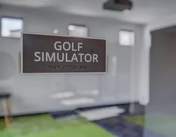 A sign that says "GOLF SIMULATOR" is hanging on a wall.