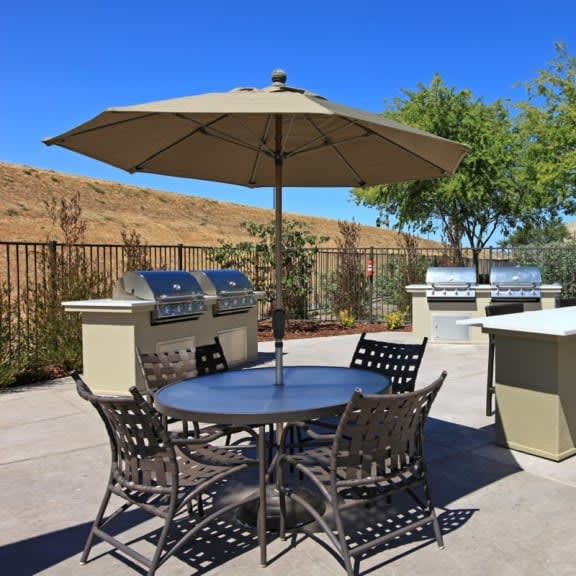 a table with a umbrella and chairs on a patio