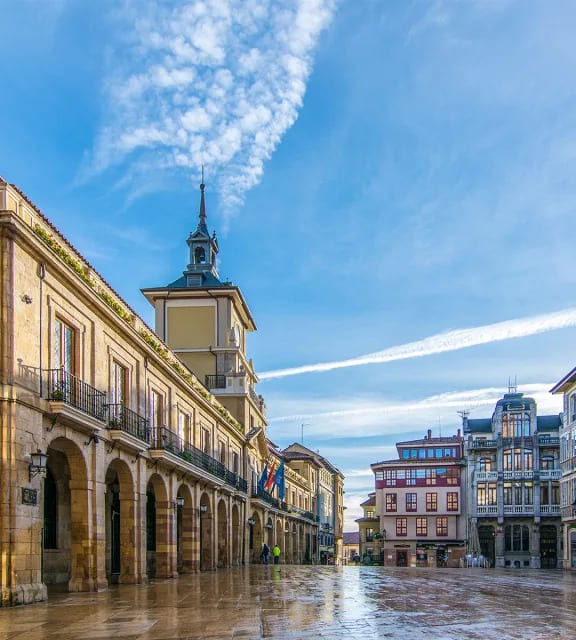a city square with buildings and a clock tower