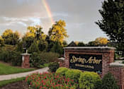 Thumbnail 1 of 6 - a rainbow in the sky above the spring airor sign
