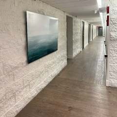A long hallway with a painting on the wall.