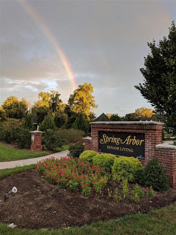 a rainbow in the sky above the spring airor sign