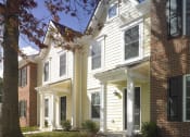 Thumbnail 6 of 6 - a row of town homes with white siding and brick