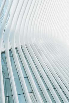 A building with a white facade and curved lines.