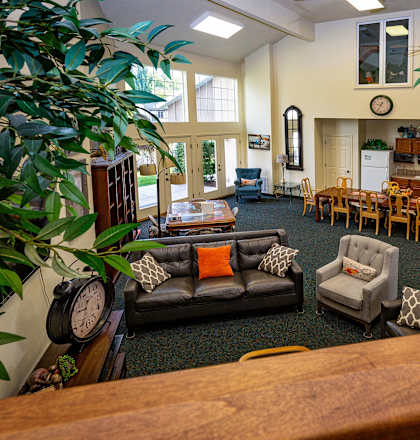 a living room with couches and chairs and a table