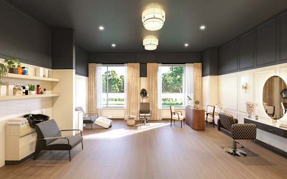 A spacious waiting room with a large mirror and comfortable seating.