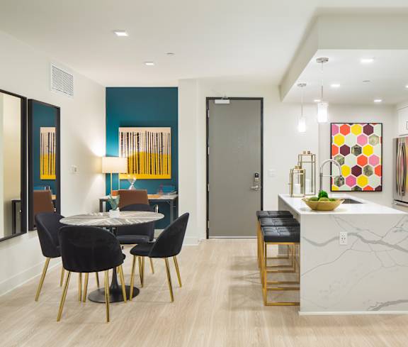 A modern kitchen with a dining table and chairs.