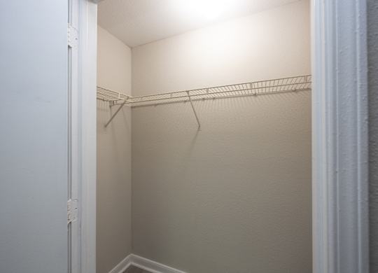 an empty closet in a small room with a white door at Magnolia Pointe Apartments in Duluth, GA