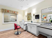 Thumbnail 3 of 5 - a bathroom with a sink and a mirror and a chair