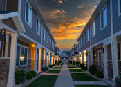 Thumbnail 1 of 4 - A row of houses with a pathway in the middle.