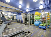 Thumbnail 9 of 9 - a gym with a treadmill and weights and balloons