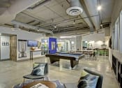Thumbnail 8 of 9 - a game room with a pool table and chairs