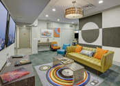 Thumbnail 5 of 9 - a living room with a yellow couch and a coffee table
