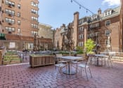 Thumbnail 16 of 20 - a rendering of a patio with tables and chairs in a courtyard