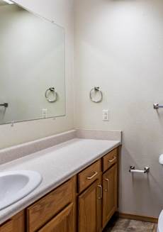 the view of a bathroom with a sink toilet and mirror