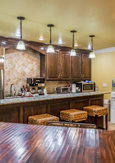 a kitchen with a bar and a dining table
