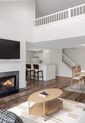 a living room with a fire place and a ceiling fan  at Residences at Westborough Station, Westborough