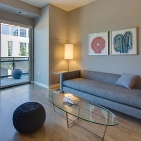 a living room with a couch and a glass coffee table