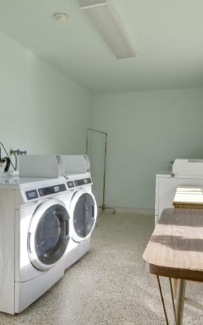 a laundry room with a sink and a washing machine
