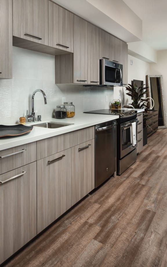 model kitchen with stainless steel appliances at Topaz Apartments, Los Angeles, 90013