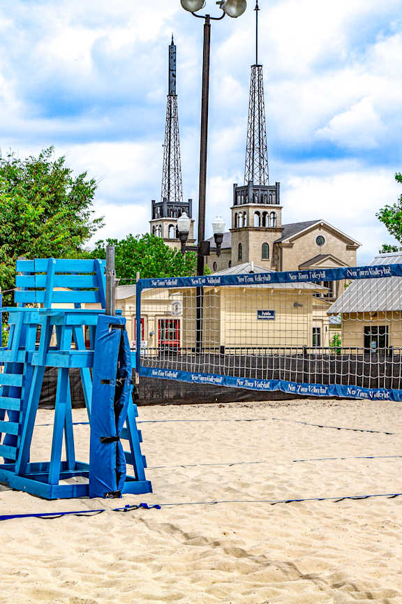 A blue lifeguard tower sits on a sandy beach at French District Villas Apartments, Missouri 63301