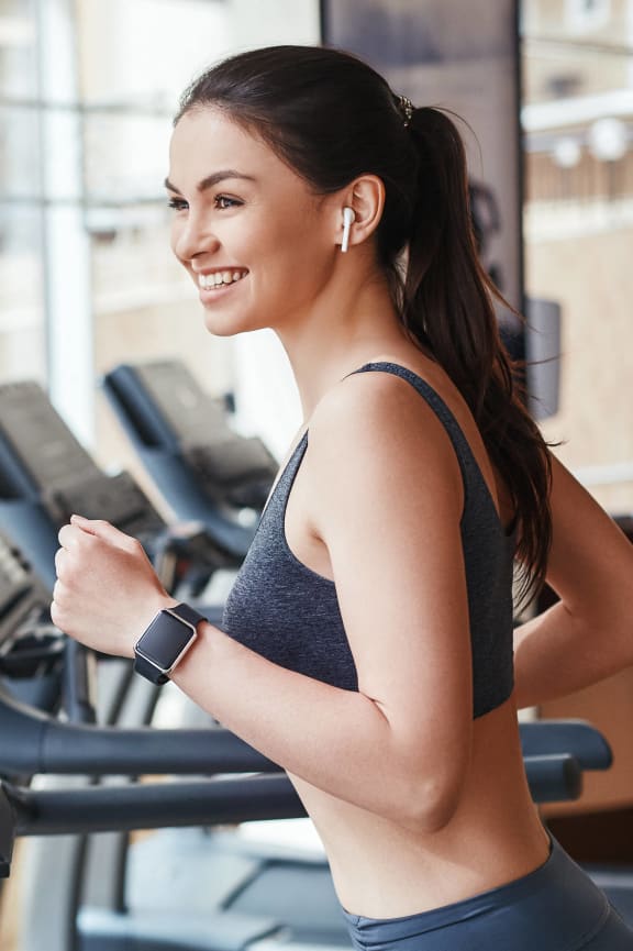 a woman running on a treadmill at a gymat Altis Grand Kendall, Florida