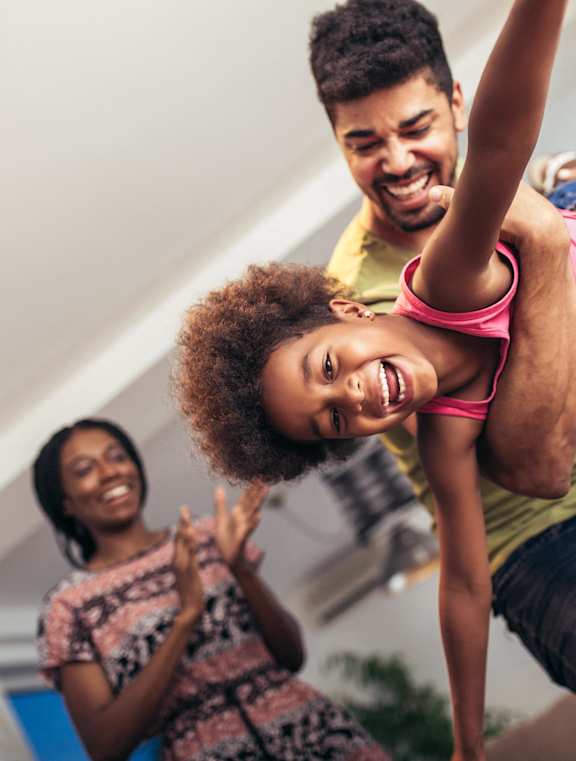 a man and a woman are playing with a girl