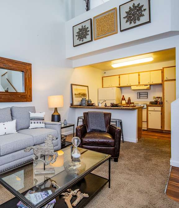 A living room with a grey couch and a coffee table.