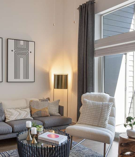 a living room with a couch and two paintings on the wall