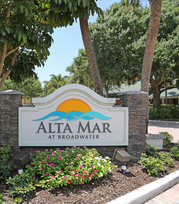 A sign that says Alta Mar at Broadwater in front of some trees.
