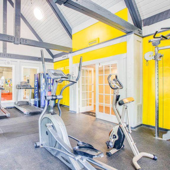 the gym with cardio equipment and weights at The Grove Brentwood in Nashville, TN