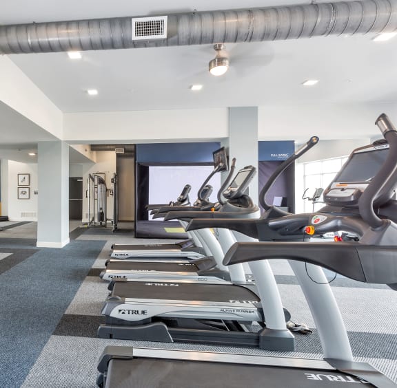 a gym with weights and a playground in the corner of a room