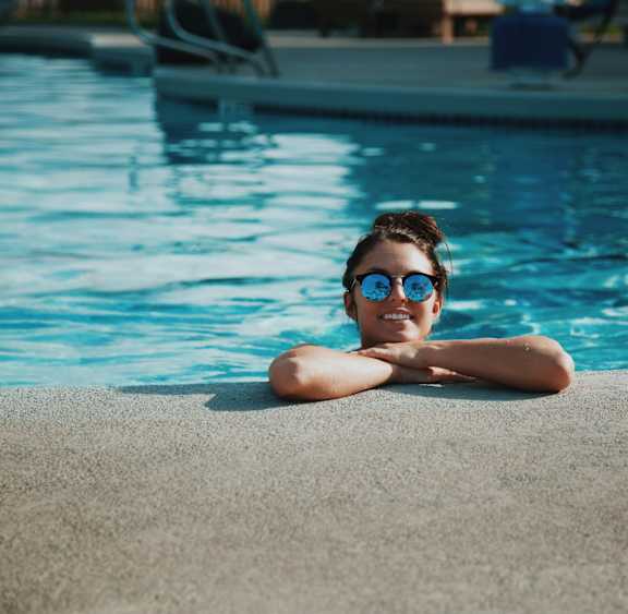 a girl with sunglasses in a swimming pool