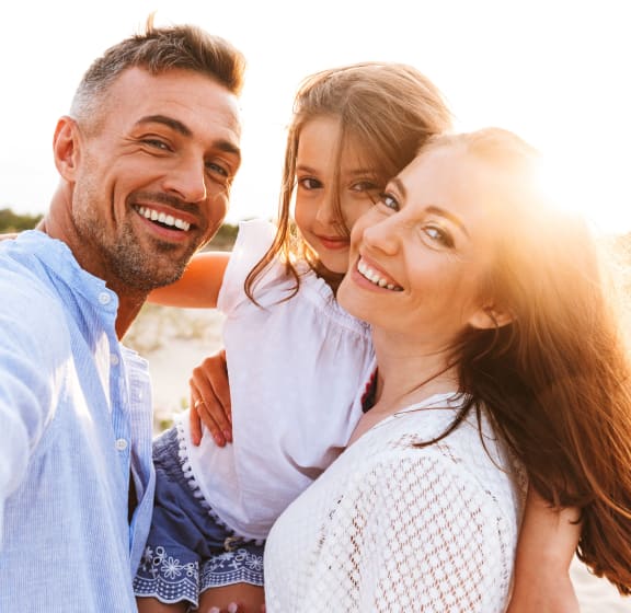 a man and two women on the beach smiling at the camera at Anchor 532 Luxury Apartments, Vallejo, CA 94590