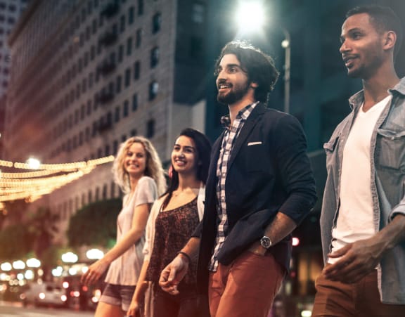 four friends walking through downtown los angeles at night