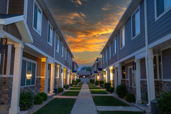 A row of houses with a pathway in the middle.