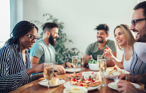 A group of people enjoying a meal together at a table.