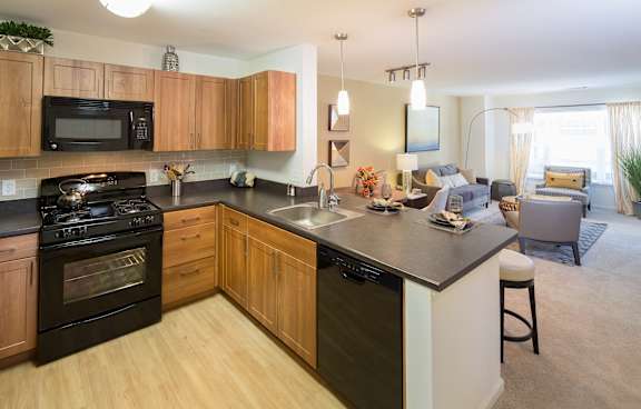 a kitchen with an island and a living room with a couch