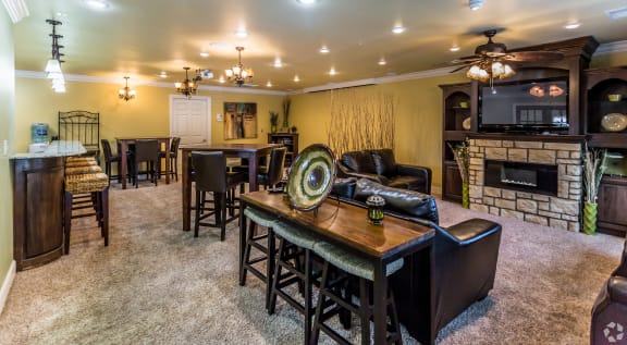 a living room with a fireplace and a table and chairs