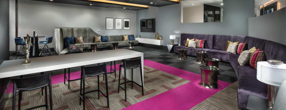 topaz clubroom with lounge seating and high tables at Topaz Apartments, Los Angeles, CA, 90013