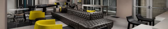 a lounge area with couches and chairs and a ping pong table