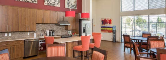 a dining room and kitchen with a table and chairs