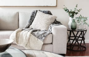 White couch with cozy blanket